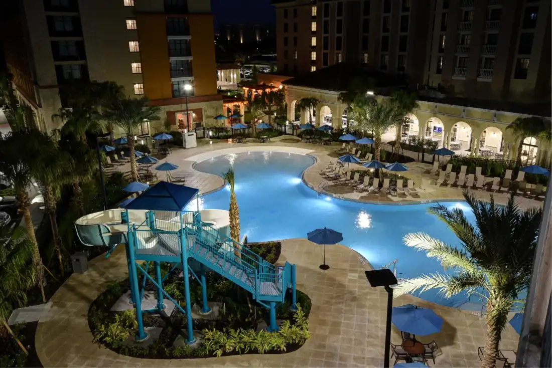 Family enjoying a resort pool near Disney World at golden hour